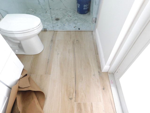 bathroom with wood-type flooring and toilet