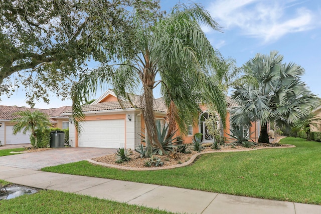 view of front of property featuring a garage, cooling unit, and a front yard