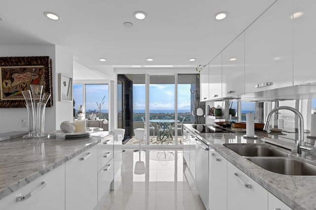 kitchen featuring black electric stovetop, light stone counters, white cabinets, sink, and stainless steel dishwasher