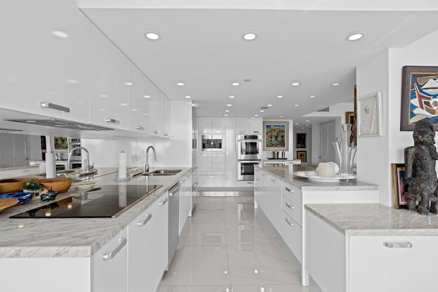 kitchen featuring a center island, appliances with stainless steel finishes, sink, and white cabinets