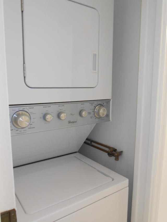 laundry area with stacked washer and dryer