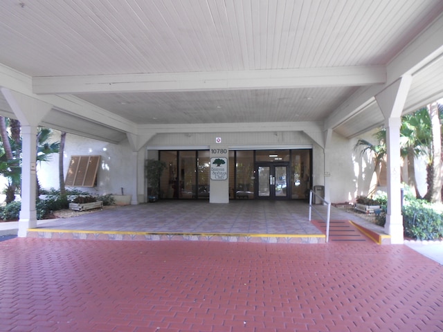 view of exterior entry with french doors and a patio