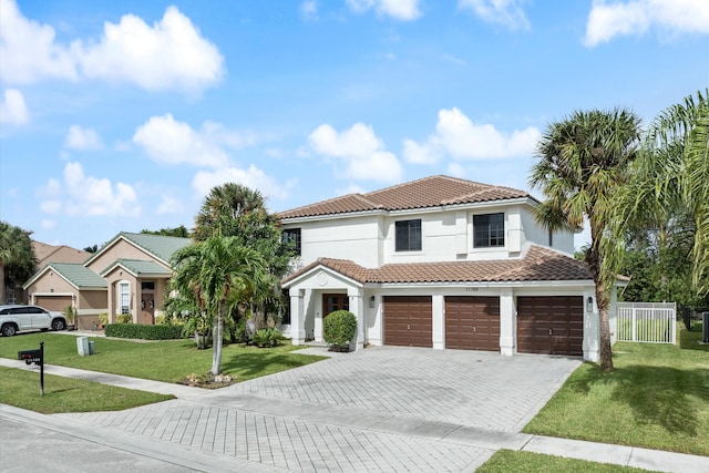 mediterranean / spanish house with a garage and a front yard