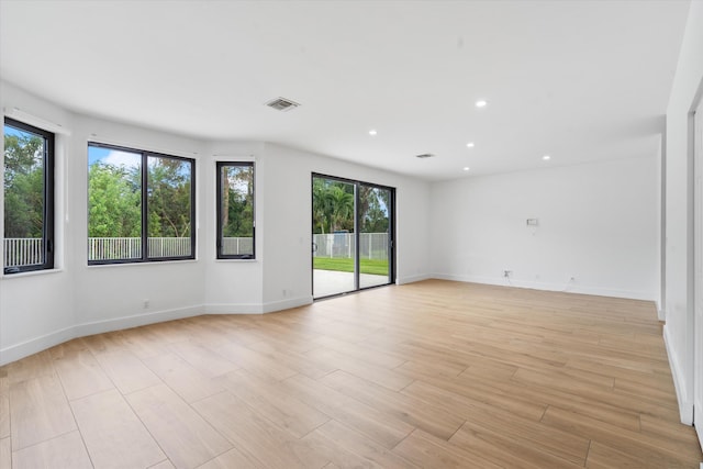 unfurnished room featuring light hardwood / wood-style floors and a healthy amount of sunlight