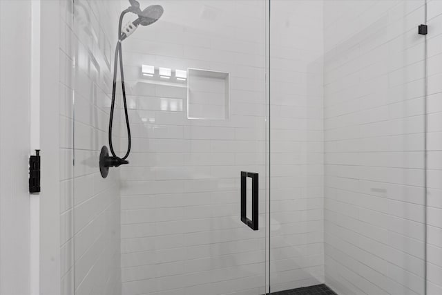 bathroom with a shower with door