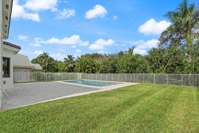 view of swimming pool featuring a yard and a patio area