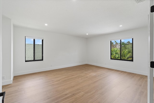 spare room featuring light wood-type flooring