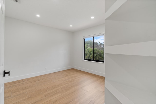 spare room featuring light hardwood / wood-style floors