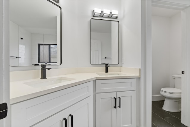 bathroom with vanity, tile patterned floors, and toilet