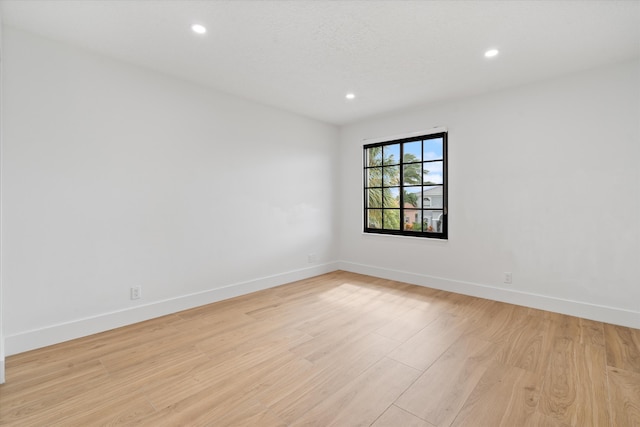 unfurnished room with light hardwood / wood-style flooring