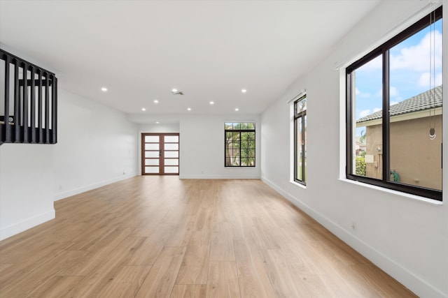 spare room with light hardwood / wood-style flooring