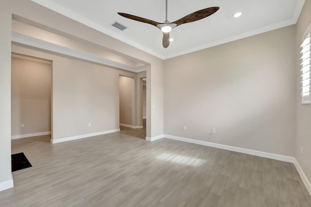 spare room with ceiling fan, light hardwood / wood-style floors, and crown molding