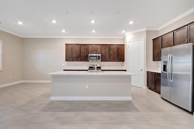 kitchen with stainless steel appliances, a center island with sink, sink, ornamental molding, and dark brown cabinets