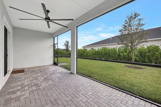 unfurnished sunroom with ceiling fan