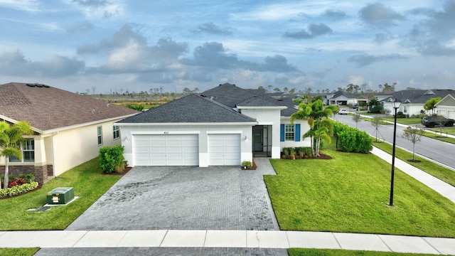 view of front of property with a garage and a front yard