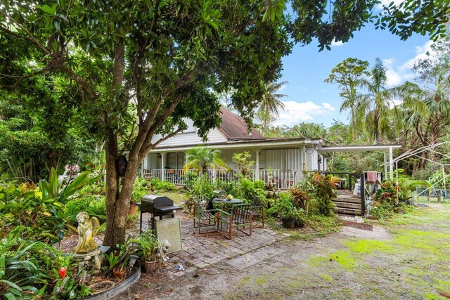 back of house featuring covered porch