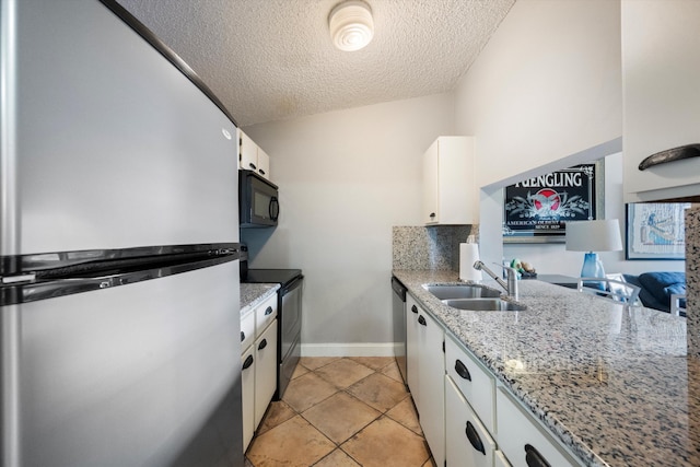 kitchen with sink, light stone counters, a textured ceiling, white cabinets, and black appliances