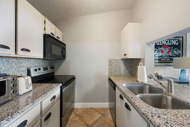 kitchen with white cabinetry, sink, appliances with stainless steel finishes, a textured ceiling, and light stone counters