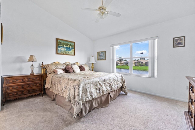 bedroom with ceiling fan, a water view, lofted ceiling, and light colored carpet