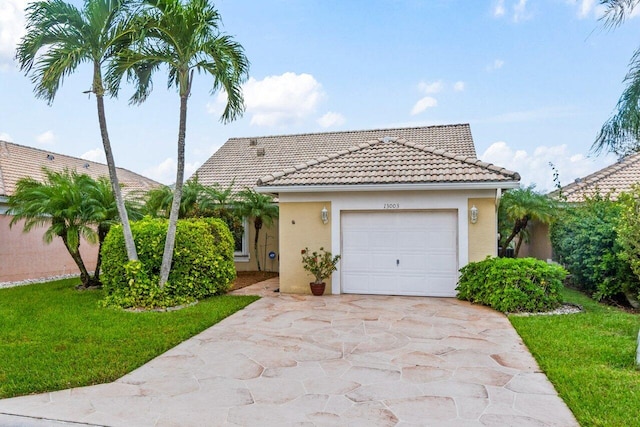 view of front of house featuring a garage and a front lawn