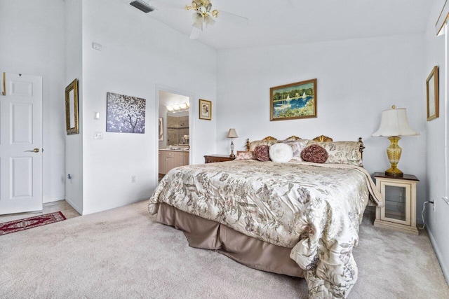 carpeted bedroom featuring ceiling fan, ensuite bath, and high vaulted ceiling