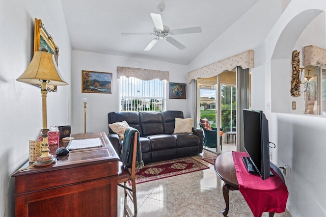 living room featuring ceiling fan and vaulted ceiling