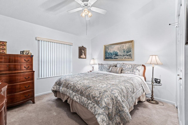 bedroom with ceiling fan, lofted ceiling, and light colored carpet