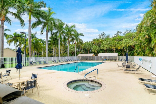 view of swimming pool with a hot tub and a patio area