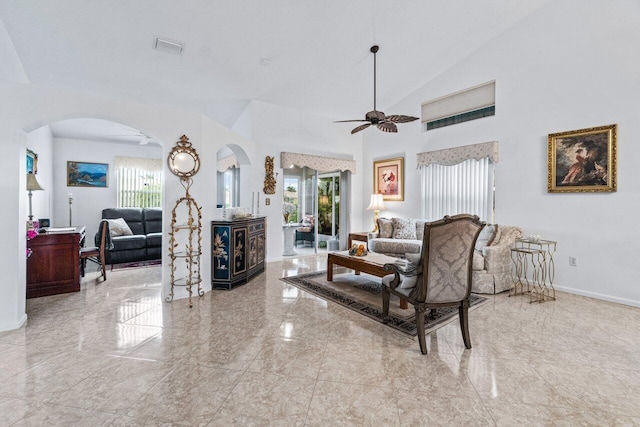 living room featuring ceiling fan, vaulted ceiling, and a healthy amount of sunlight