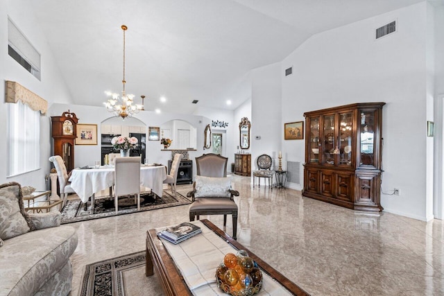 living room with high vaulted ceiling and a chandelier