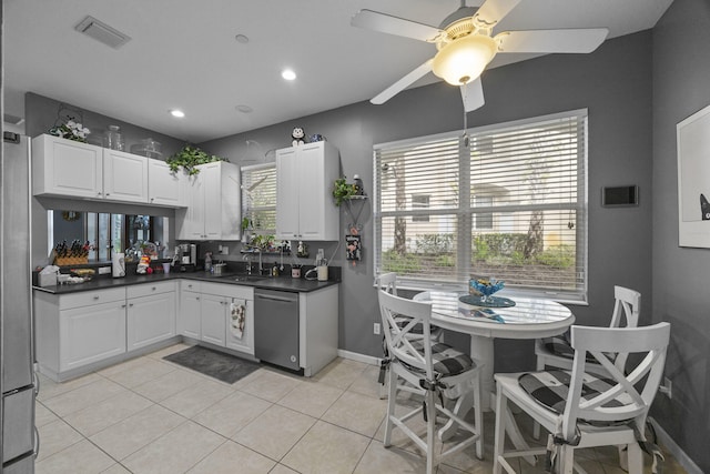 kitchen featuring dishwasher, white cabinetry, ceiling fan, and light tile patterned flooring