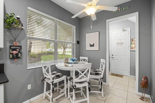 tiled dining space with ceiling fan