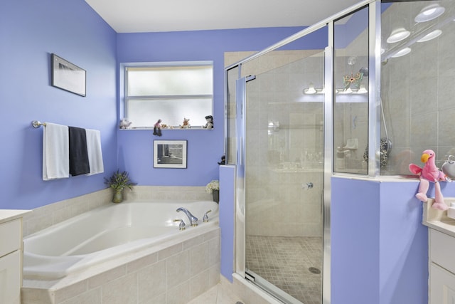 bathroom featuring shower with separate bathtub and vanity