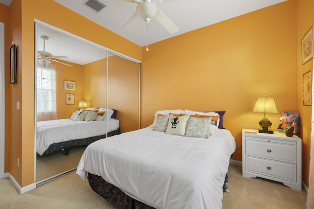 carpeted bedroom featuring a closet and ceiling fan