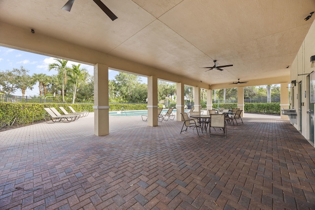 view of patio featuring a community pool and ceiling fan