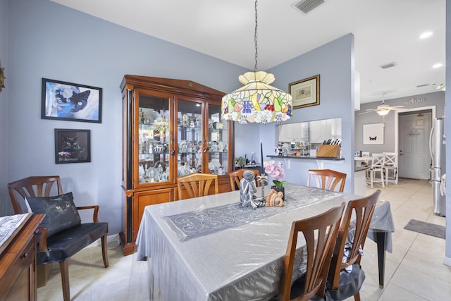 tiled dining room featuring ceiling fan