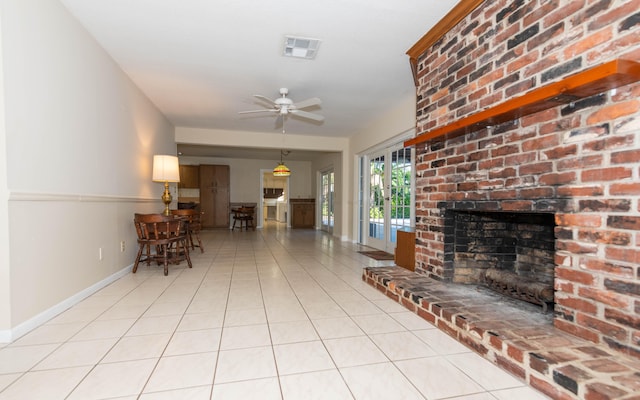 living room featuring light tile patterned floors, a brick fireplace, and ceiling fan