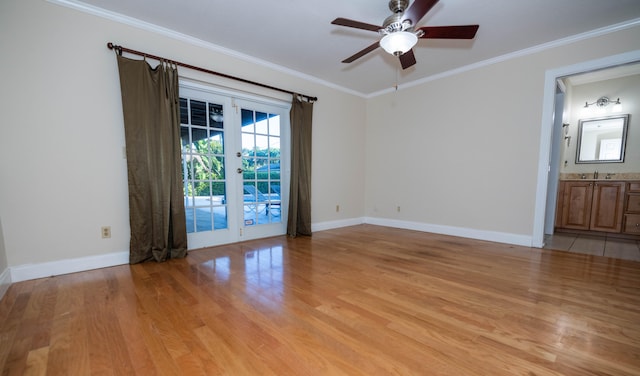 spare room featuring ceiling fan, sink, french doors, light hardwood / wood-style flooring, and ornamental molding