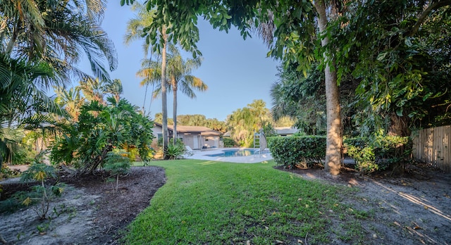 view of yard with a fenced in pool