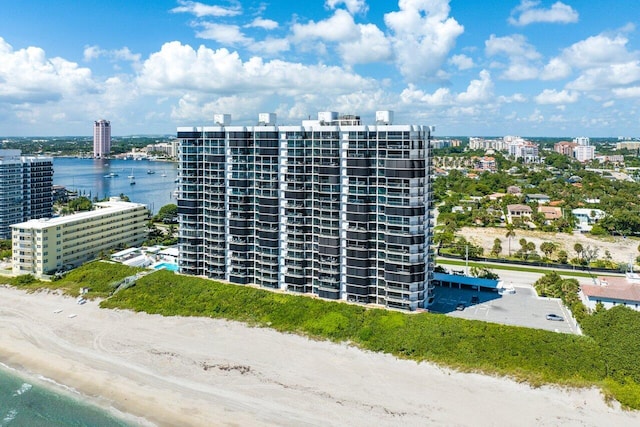 view of property with a water view and a view of the beach