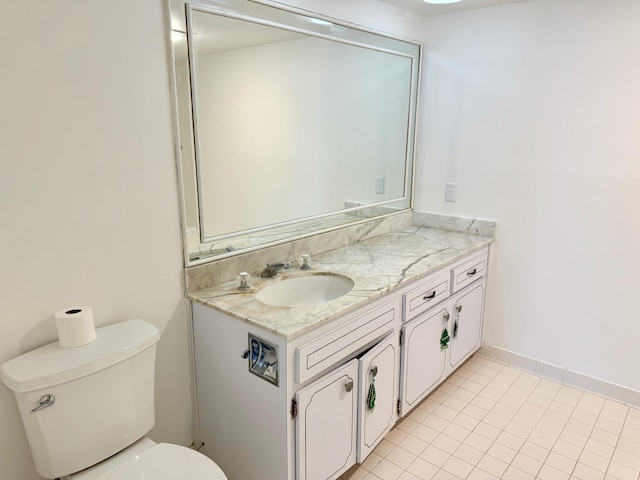 bathroom with toilet, tile patterned floors, and vanity