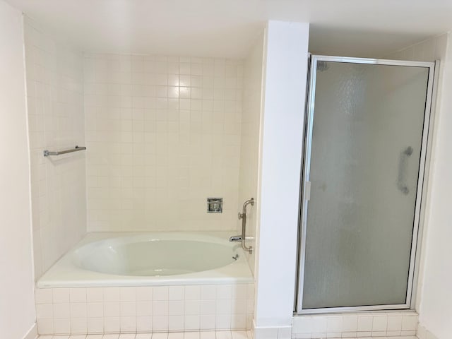 bathroom with separate shower and tub and tile patterned flooring