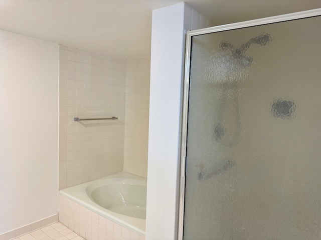 bathroom with independent shower and bath and tile patterned flooring