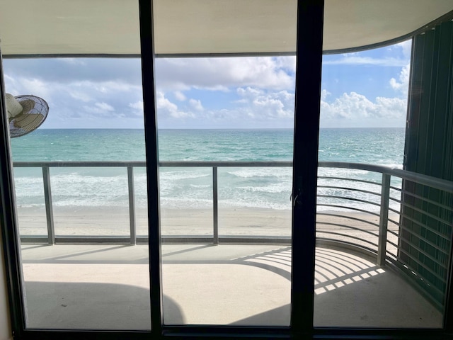 interior space featuring a water view and a view of the beach