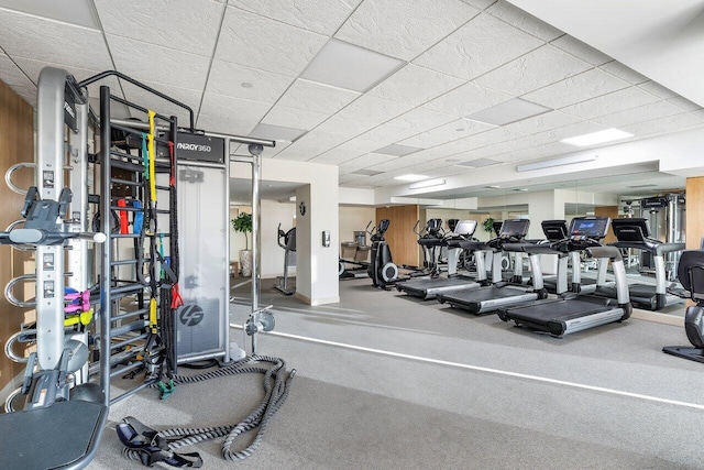 gym with a paneled ceiling