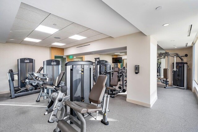 workout area featuring a paneled ceiling