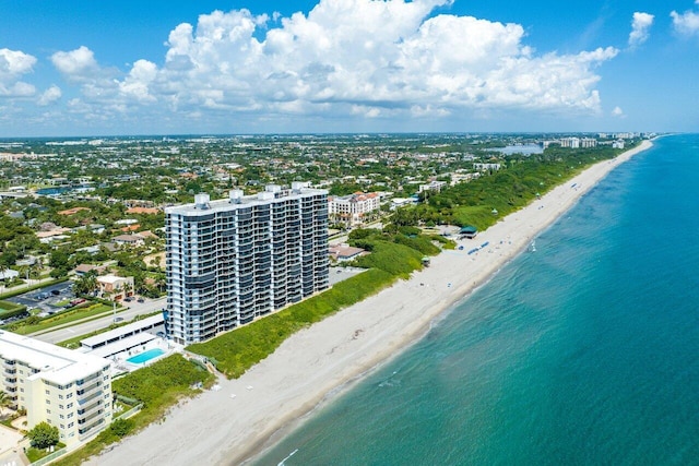 bird's eye view featuring a water view and a beach view