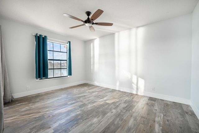 empty room with ceiling fan and wood-type flooring