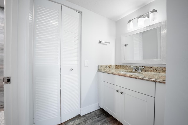 bathroom featuring vanity, a textured ceiling, and hardwood / wood-style floors