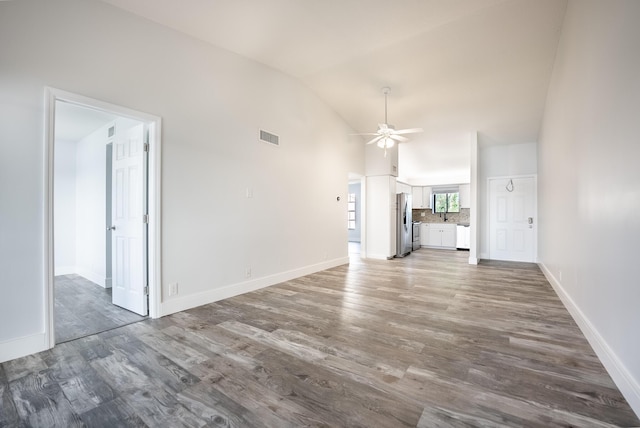 unfurnished living room with ceiling fan, wood-type flooring, and lofted ceiling